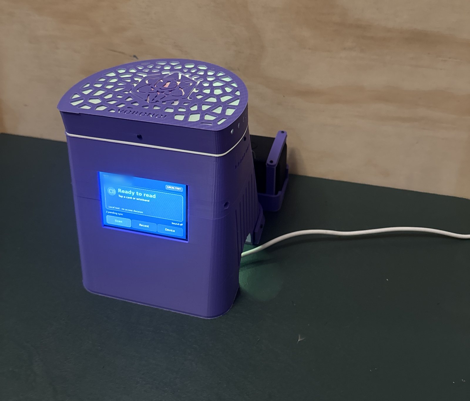 The second kiosk prototype on a bench: purple printed body, backlit Voronoi lid, touchscreen reading Ready to read